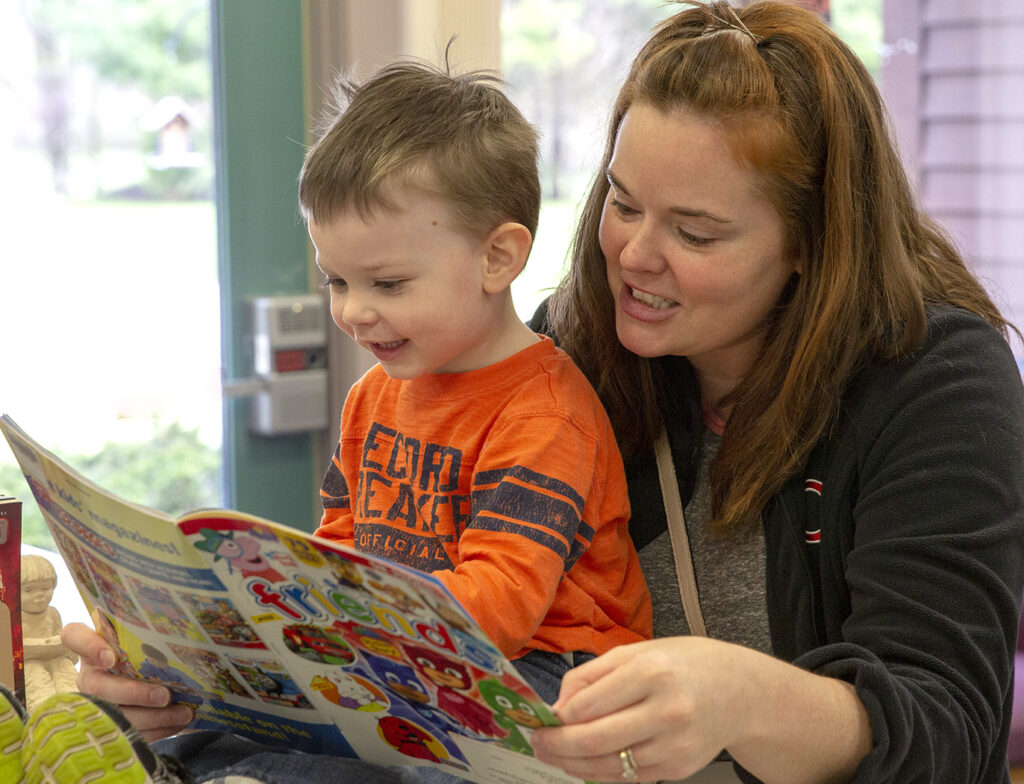 Woman teaches child to read at Elkhart Public Library