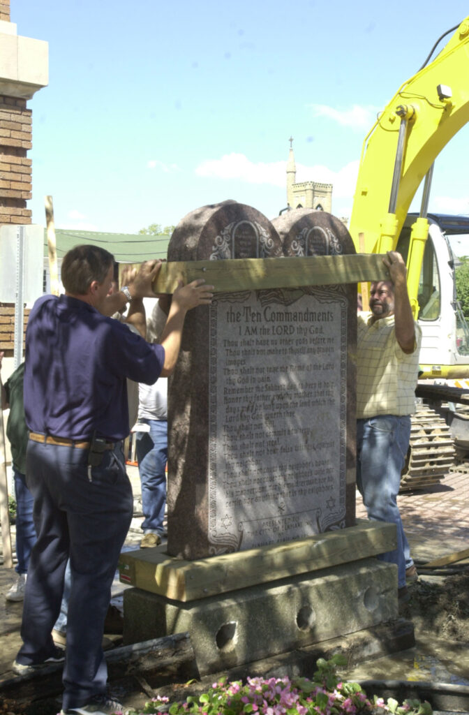 Workers stabilize the Ten Commandments monument prior to its move.